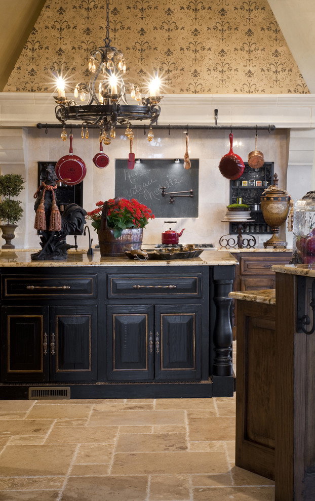 Design ideas for a mediterranean kitchen in Oklahoma City with raised-panel cabinets and black cabinets.