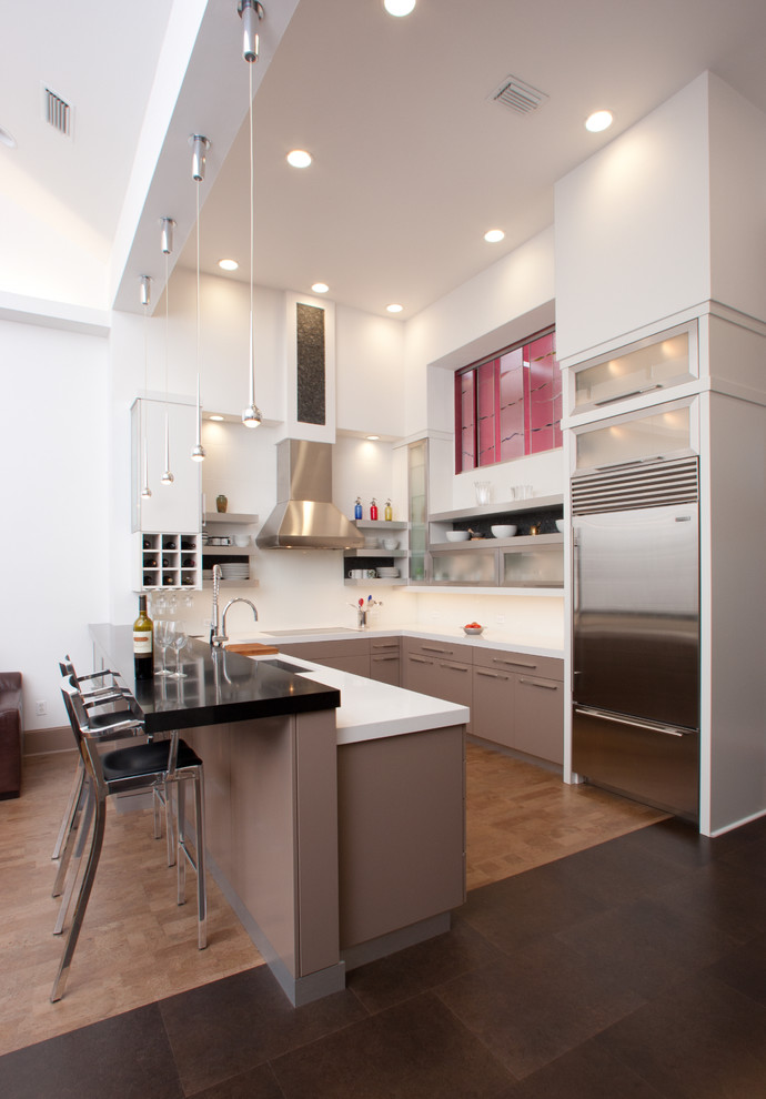 Photo of a contemporary u-shaped kitchen in Miami with stainless steel appliances.