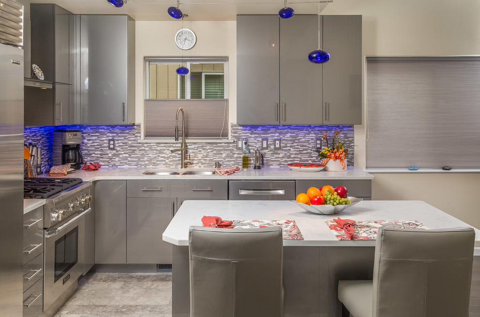 This is an example of a small contemporary l-shaped open plan kitchen in Other with a submerged sink, flat-panel cabinets, grey cabinets, tile countertops, multi-coloured splashback, mosaic tiled splashback, stainless steel appliances, porcelain flooring and an island.