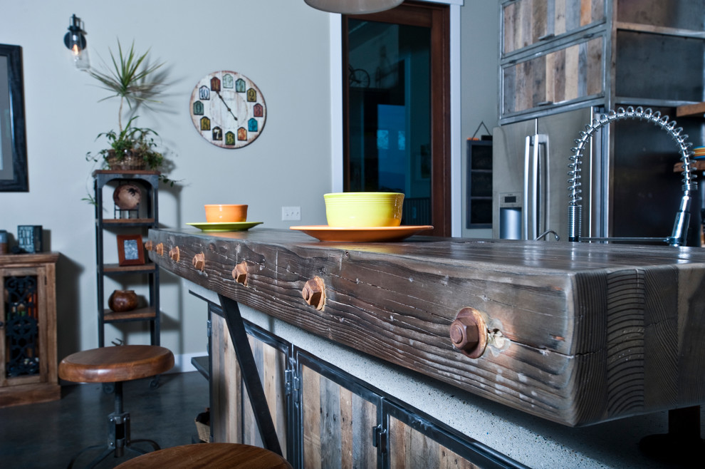 Open concept kitchen - large industrial galley concrete floor open concept kitchen idea in Other with a double-bowl sink, distressed cabinets, recycled glass countertops, metallic backsplash, stainless steel appliances and an island