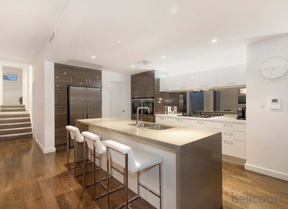 Open concept kitchen - contemporary l-shaped open concept kitchen idea in Perth with an undermount sink, flat-panel cabinets, white cabinets, stainless steel appliances and an island