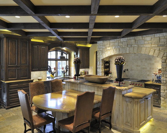 Mid-sized mountain style u-shaped slate floor and beige floor eat-in kitchen photo in St Louis with a single-bowl sink, raised-panel cabinets, distressed cabinets, granite countertops, paneled appliances and an island