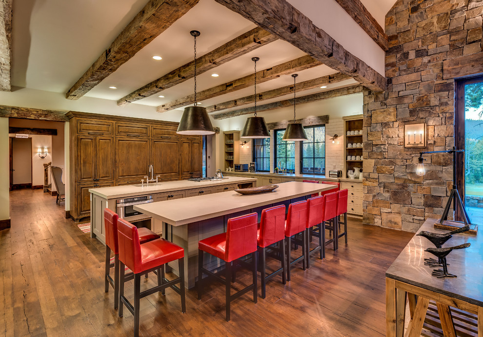 Inspiration for a mid-sized rustic single-wall medium tone wood floor and beige floor open concept kitchen remodel in Sacramento with an undermount sink, raised-panel cabinets, medium tone wood cabinets, quartz countertops, white backsplash, subway tile backsplash, paneled appliances and two islands