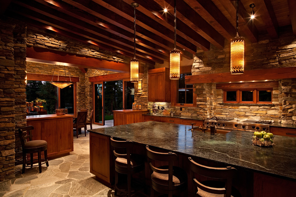 This is an example of a large rustic l-shaped kitchen/diner in Sacramento with a belfast sink, recessed-panel cabinets, medium wood cabinets, engineered stone countertops, beige splashback, stone tiled splashback, stainless steel appliances, travertine flooring, an island and beige floors.