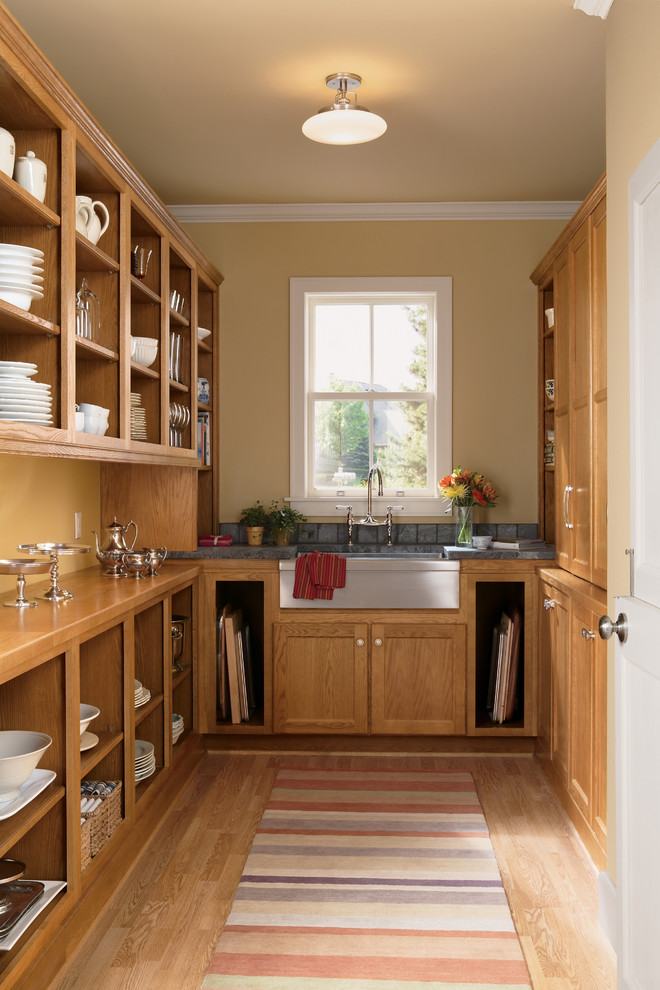 Kitchen pantry - mid-sized cottage u-shaped medium tone wood floor and brown floor kitchen pantry idea in Other with medium tone wood cabinets, a farmhouse sink, shaker cabinets, wood countertops, stainless steel appliances and no island