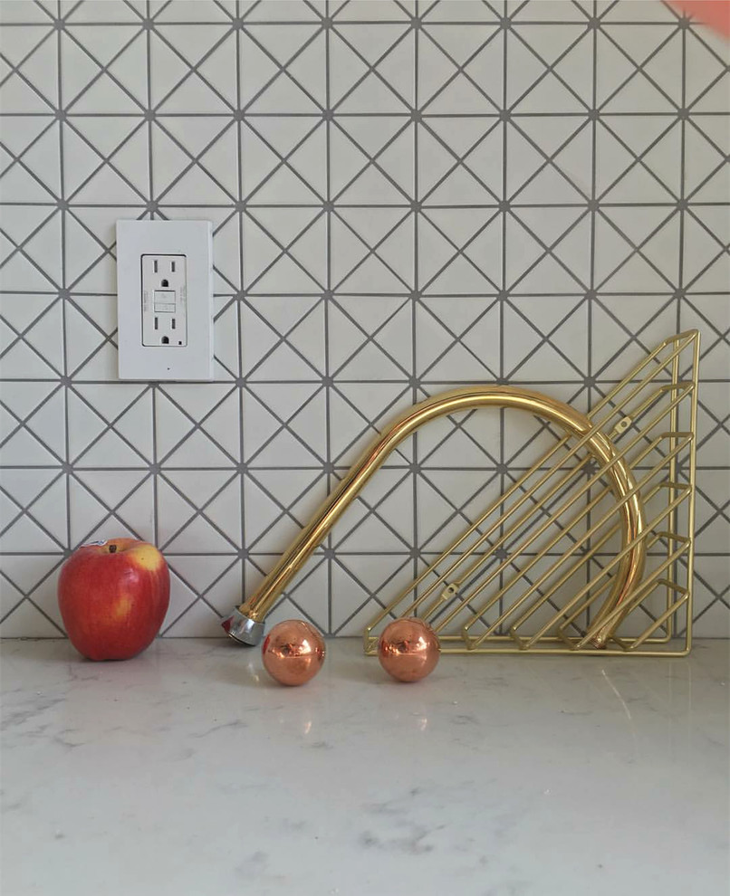 На фото: кухня в стиле модернизм с обеденным столом, столешницей из кварцевого агломерата, белым фартуком и фартуком из плитки мозаики