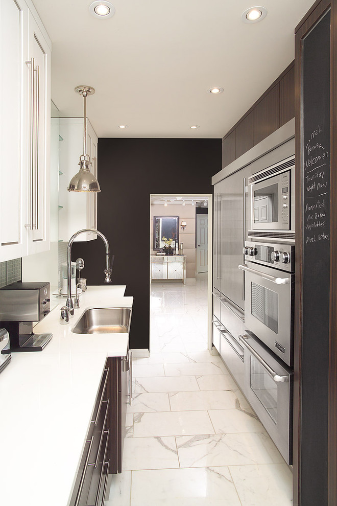 Inspiration for a contemporary galley enclosed kitchen remodel in Toronto with stainless steel appliances