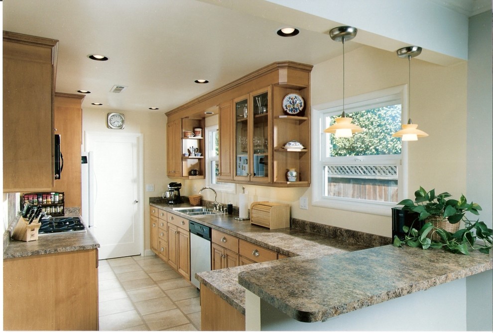 Inspiration for a small timeless galley ceramic tile eat-in kitchen remodel in Sacramento with a double-bowl sink, raised-panel cabinets, medium tone wood cabinets, solid surface countertops, multicolored backsplash, no island, stone slab backsplash and stainless steel appliances