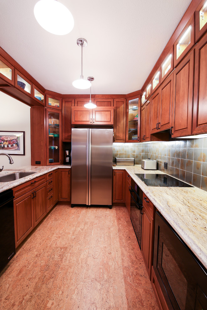 Photo of a medium sized modern galley enclosed kitchen in San Francisco with a submerged sink, glass-front cabinets, red cabinets, granite worktops, grey splashback, ceramic splashback, stainless steel appliances, cork flooring and red floors.