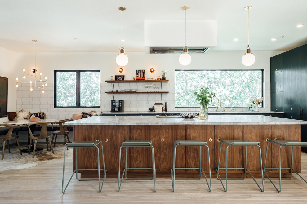 Inspiration for a large bohemian l-shaped open plan kitchen in Salt Lake City with a built-in sink, flat-panel cabinets, green cabinets, marble worktops, white splashback, ceramic splashback, coloured appliances, light hardwood flooring and an island.