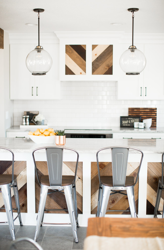 Eat-in kitchen - mid-sized cottage ceramic tile and gray floor eat-in kitchen idea in Minneapolis with a farmhouse sink, shaker cabinets, white cabinets, granite countertops, white backsplash, ceramic backsplash, stainless steel appliances and an island