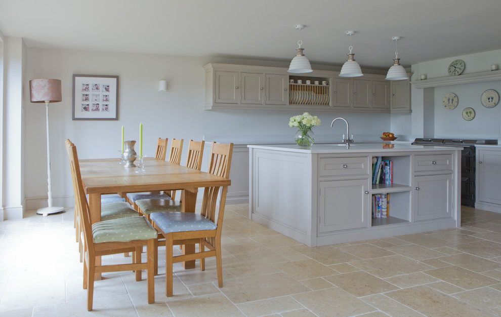 Mid-sized elegant l-shaped beige floor eat-in kitchen photo in Wiltshire with recessed-panel cabinets, an island, an undermount sink, beige cabinets, black appliances, white countertops and white backsplash
