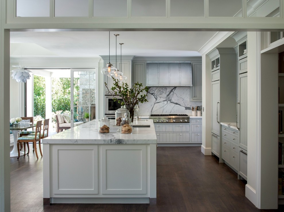 Eat-in kitchen - large country galley medium tone wood floor eat-in kitchen idea in San Francisco with an undermount sink, shaker cabinets, marble countertops, stainless steel appliances, an island, blue cabinets, white backsplash and stone slab backsplash