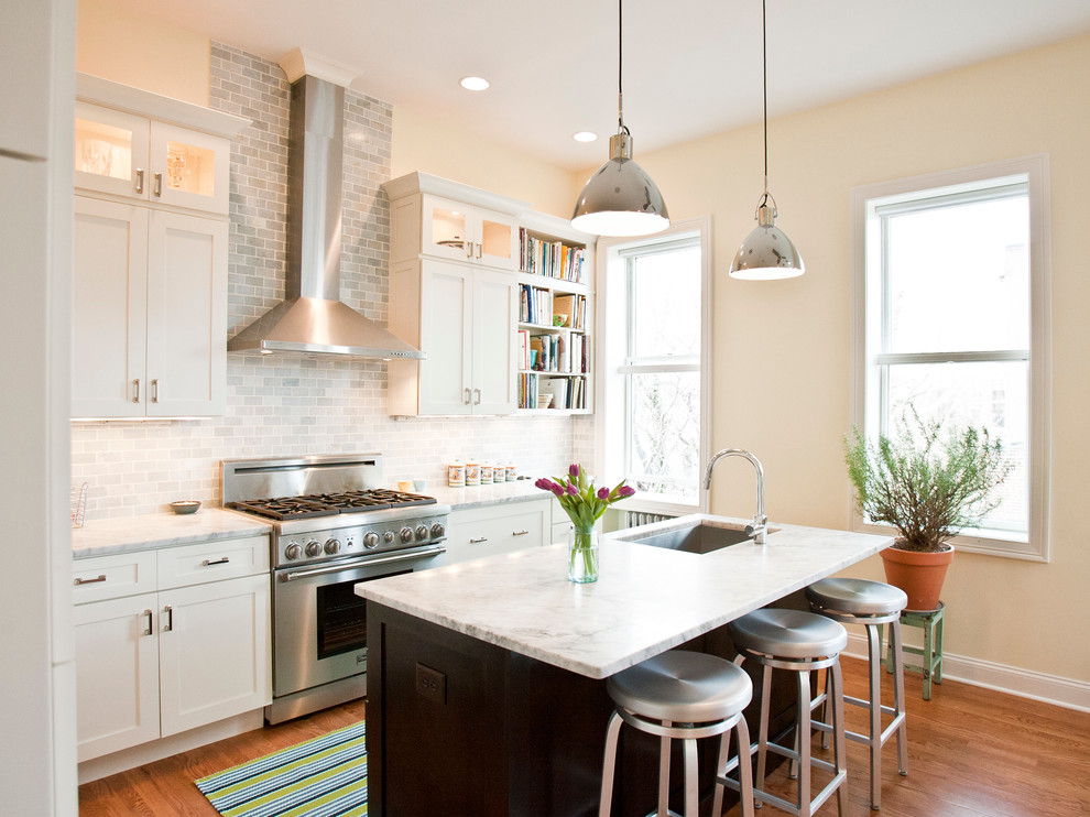 Elegant kitchen photo in New York with subway tile backsplash and stainless steel appliances