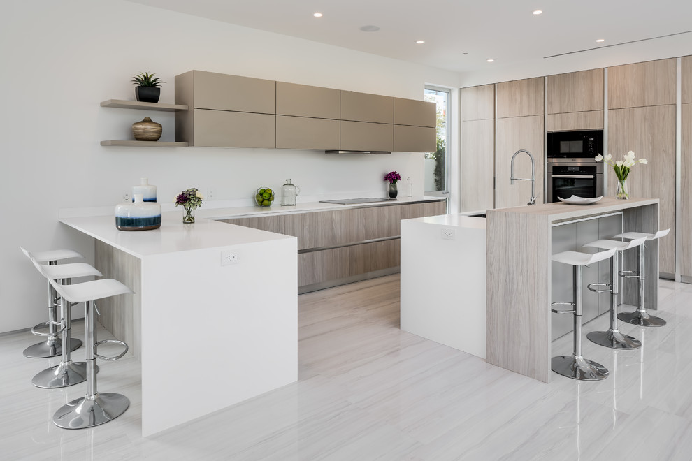 Photo of a contemporary u-shaped kitchen in Los Angeles with a submerged sink, flat-panel cabinets, medium wood cabinets, white splashback, an island, beige floors and white worktops.
