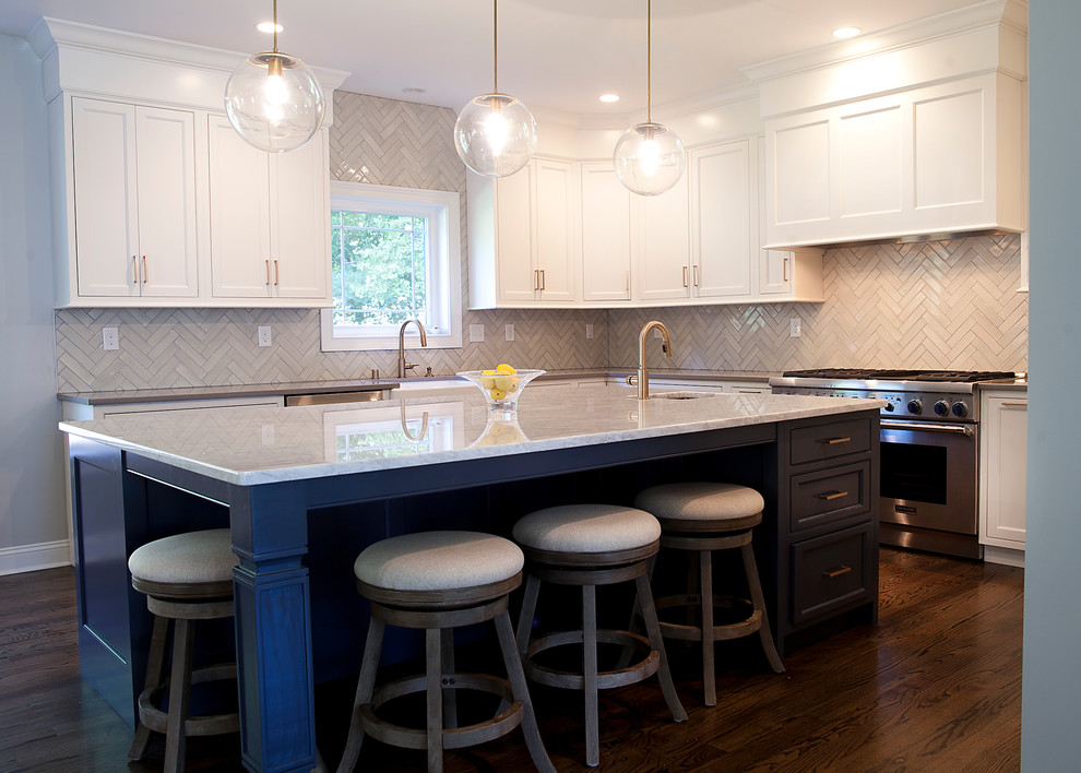 Large transitional u-shaped dark wood floor open concept kitchen photo in Philadelphia with a farmhouse sink, shaker cabinets, white cabinets, marble countertops, white backsplash, porcelain backsplash, stainless steel appliances and an island