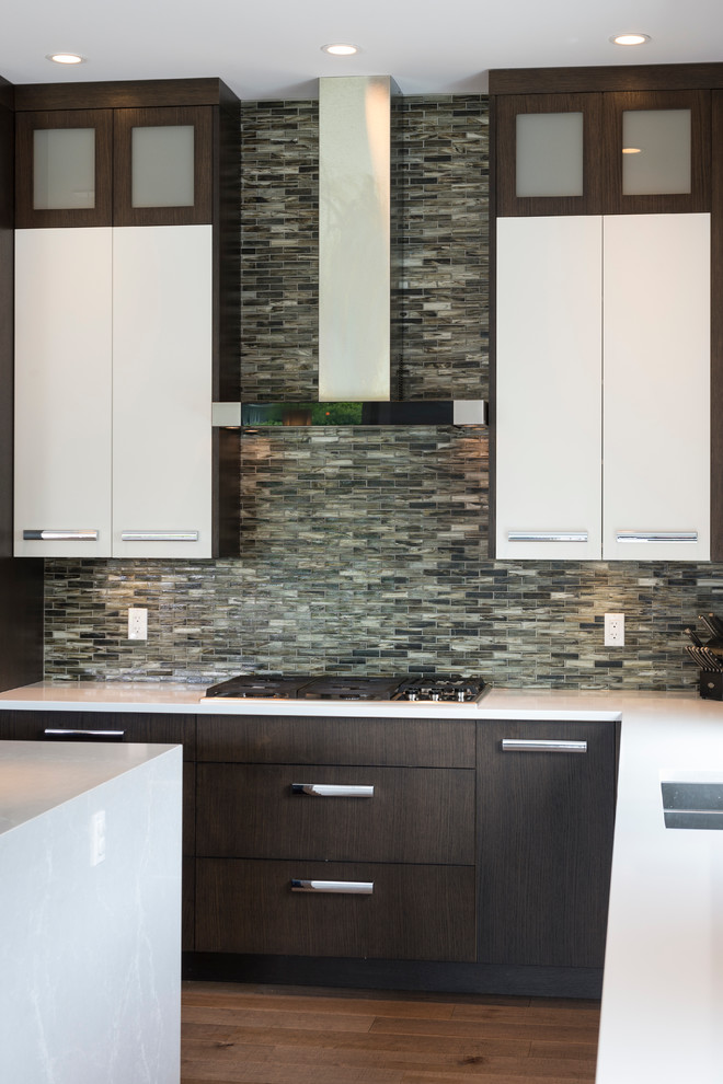 Open concept kitchen - large contemporary l-shaped medium tone wood floor open concept kitchen idea in Vancouver with an undermount sink, flat-panel cabinets, dark wood cabinets, quartz countertops, multicolored backsplash, mosaic tile backsplash, paneled appliances and an island