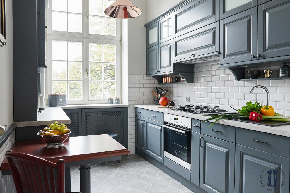 This is an example of a small traditional enclosed kitchen in Other with a built-in sink, grey cabinets, composite countertops, white appliances, terracotta flooring, grey floors and white worktops.