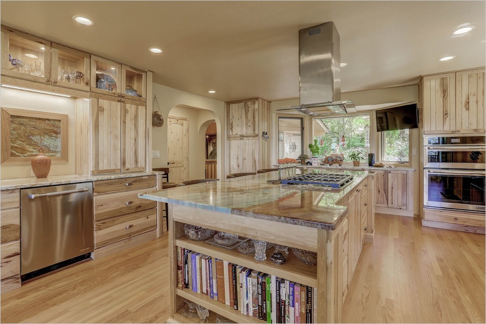 Design ideas for an expansive rustic l-shaped kitchen/diner in Denver with a belfast sink, louvered cabinets, medium wood cabinets, stainless steel appliances and an island.