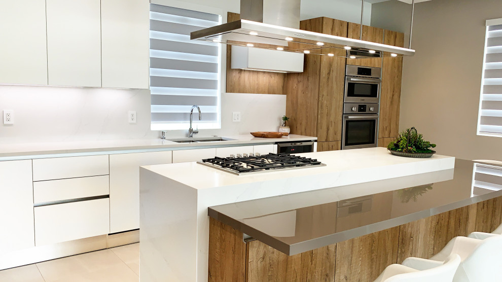 Example of a mid-sized minimalist galley porcelain tile and beige floor eat-in kitchen design in Miami with a double-bowl sink, flat-panel cabinets, medium tone wood cabinets, quartz countertops, white backsplash, slate backsplash, stainless steel appliances, an island and white countertops
