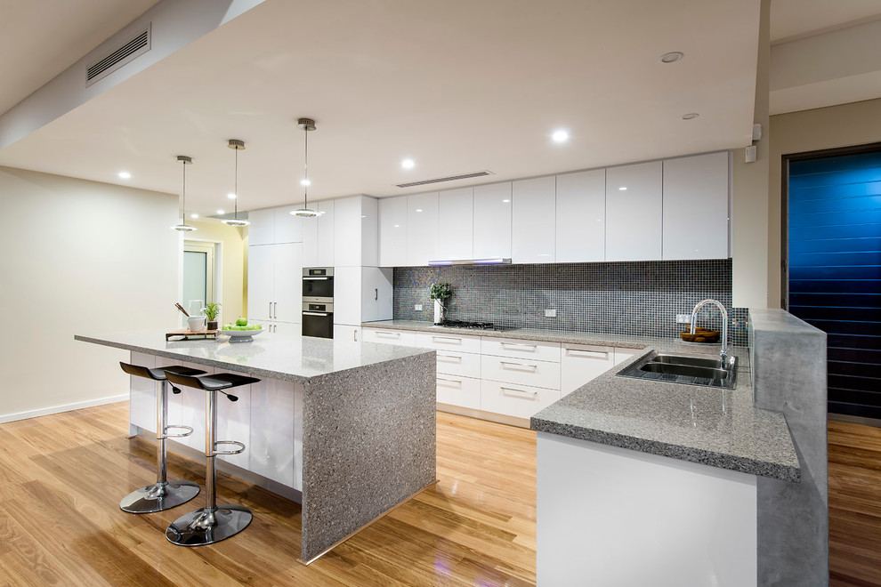 This is an example of a large contemporary kitchen in Perth with flat-panel cabinets and an island.