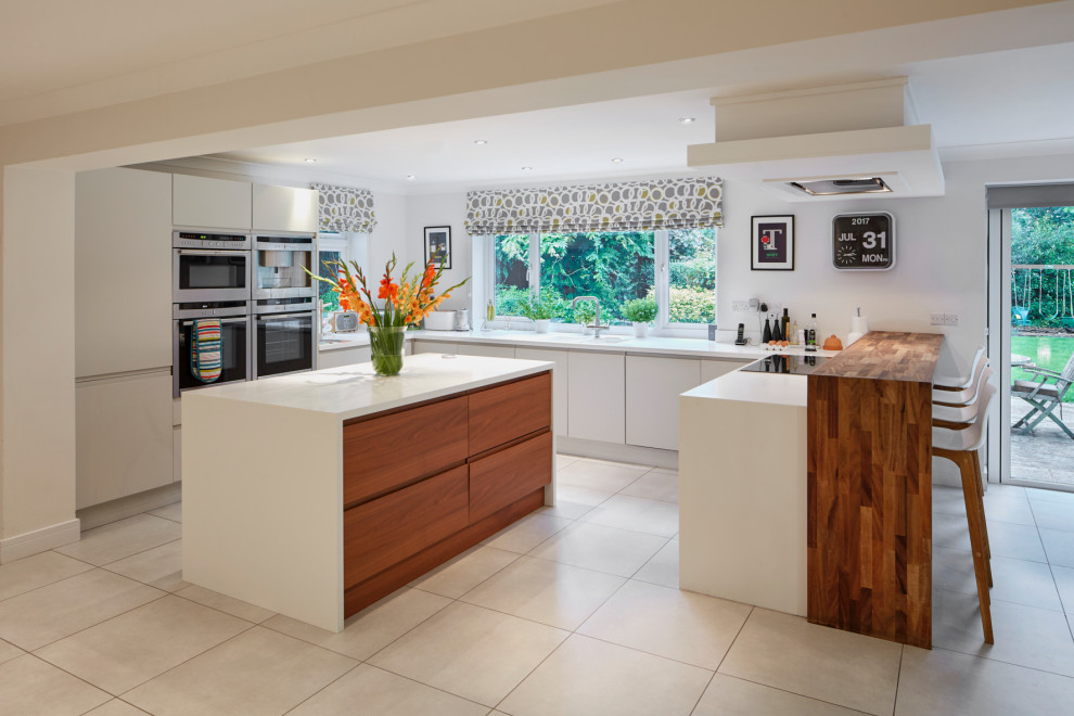 Design ideas for a contemporary kitchen in Wiltshire with an island and white worktops.