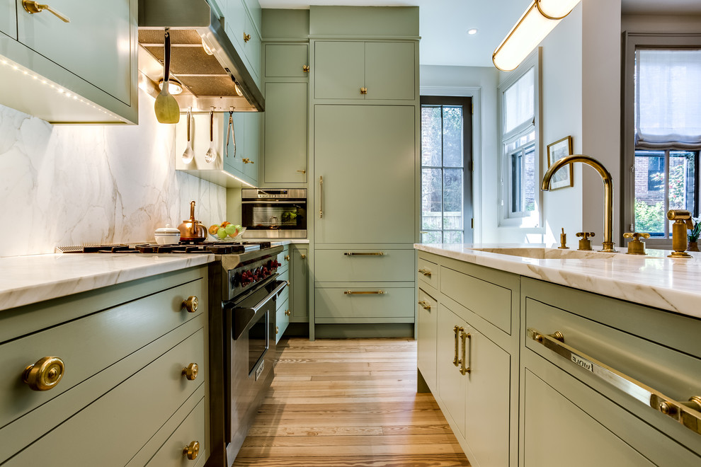 Kitchen - mid-sized transitional l-shaped light wood floor and brown floor kitchen idea in DC Metro with an integrated sink, flat-panel cabinets, green cabinets, quartzite countertops, stainless steel appliances and an island