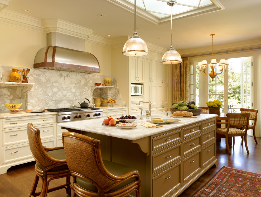 Elegant eat-in kitchen photo in San Francisco with recessed-panel cabinets, beige cabinets, white backsplash and marble backsplash