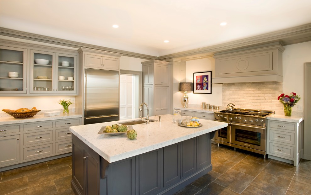 Example of a classic kitchen design in Boston with stainless steel appliances, a single-bowl sink, glass-front cabinets, gray cabinets and beige backsplash