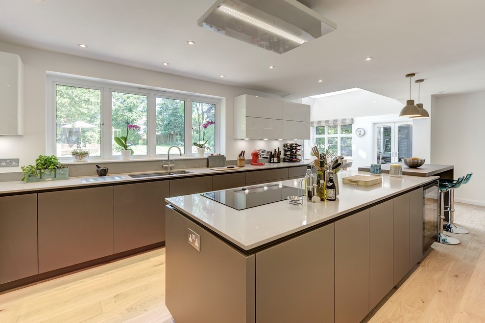 This is an example of a large contemporary u-shaped kitchen in London with an island.
