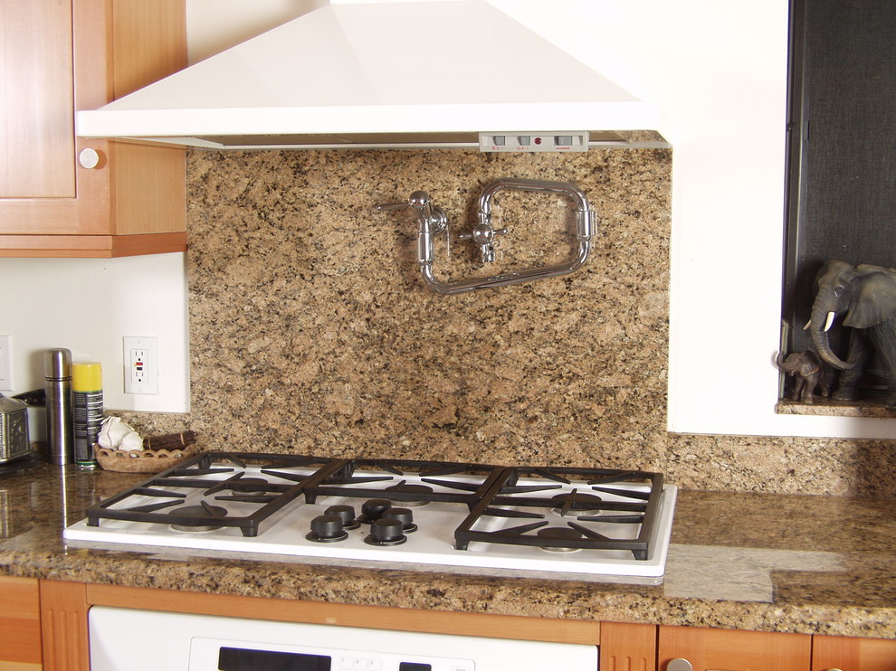 Example of a trendy u-shaped eat-in kitchen design in Seattle with a double-bowl sink, flat-panel cabinets, light wood cabinets, granite countertops, yellow backsplash, stone slab backsplash and white appliances