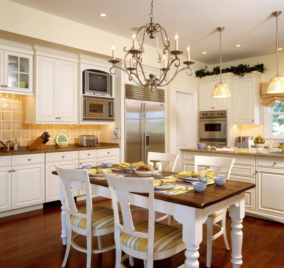 This is an example of a classic kitchen in DC Metro with raised-panel cabinets and stainless steel appliances.