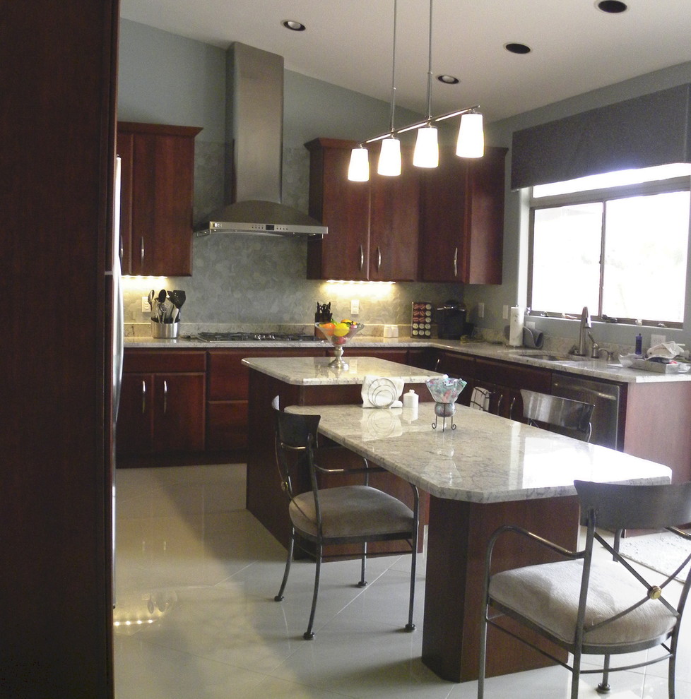 Example of a mid-sized trendy marble floor eat-in kitchen design in Phoenix with a double-bowl sink, flat-panel cabinets, dark wood cabinets, granite countertops, gray backsplash, glass sheet backsplash, stainless steel appliances and an island