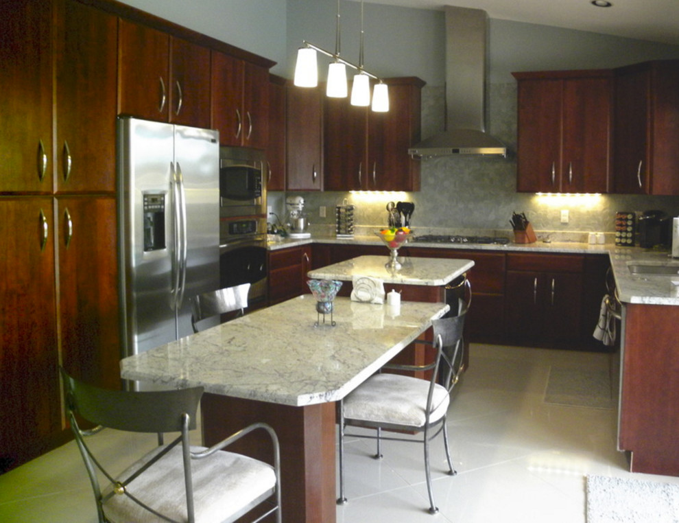 Example of a mid-sized trendy marble floor eat-in kitchen design in Phoenix with a single-bowl sink, flat-panel cabinets, dark wood cabinets, granite countertops, gray backsplash, glass tile backsplash, stainless steel appliances and two islands