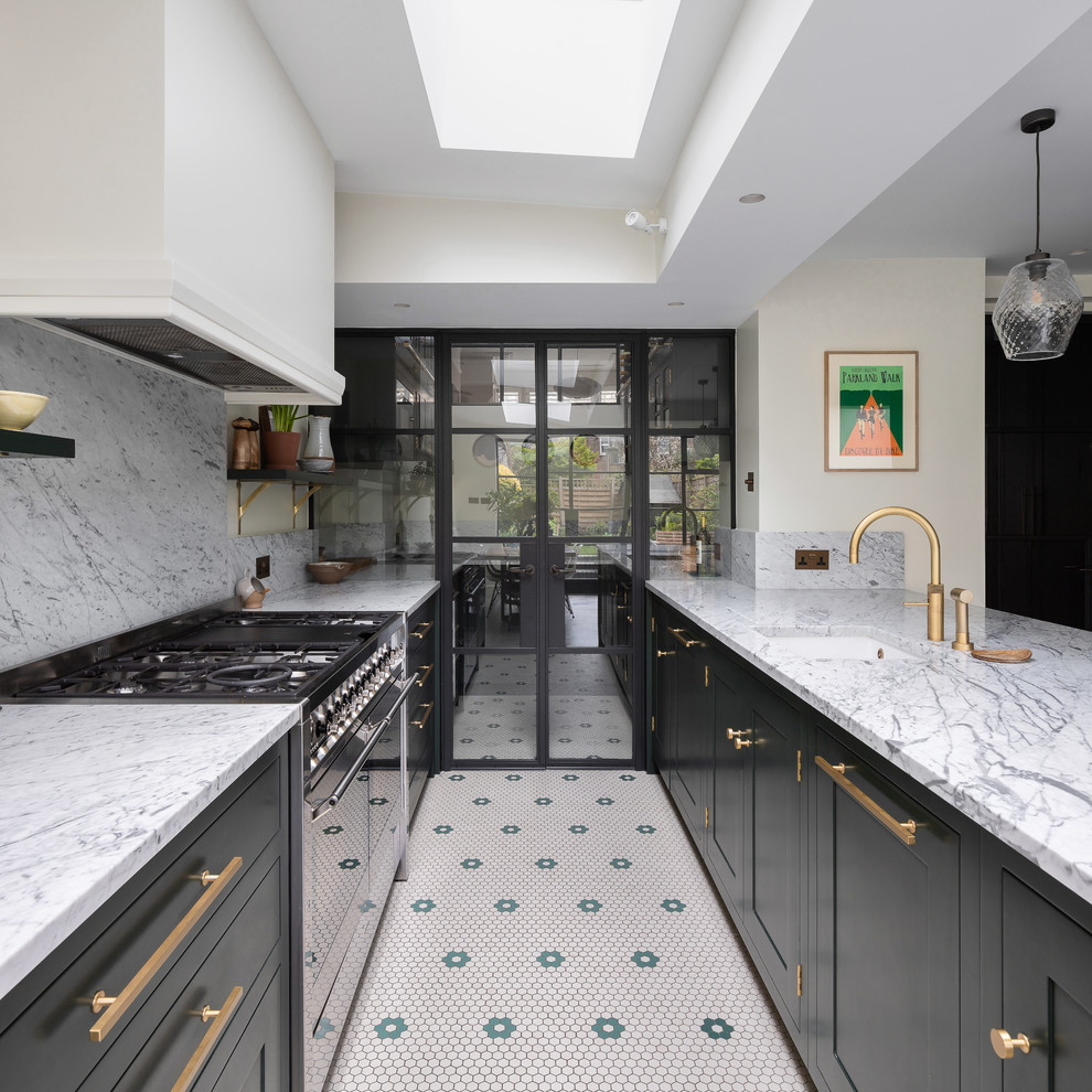 Medium sized contemporary u-shaped kitchen/diner in London with an integrated sink, shaker cabinets, green cabinets, marble worktops, white splashback, marble splashback, stainless steel appliances, porcelain flooring, an island, grey floors and white worktops.
