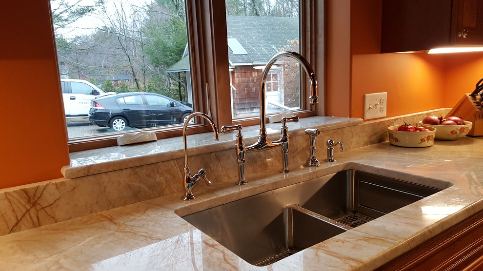 Small bohemian u-shaped enclosed kitchen in Boston with a submerged sink, raised-panel cabinets, light wood cabinets, granite worktops, stainless steel appliances, medium hardwood flooring and no island.