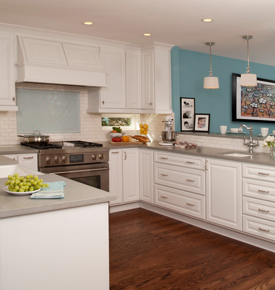 Inspiration for a timeless u-shaped dark wood floor eat-in kitchen remodel in Seattle with a farmhouse sink, raised-panel cabinets, white cabinets, white backsplash, subway tile backsplash, stainless steel appliances and a peninsula