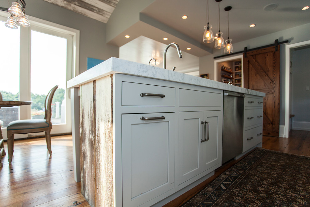 Open concept kitchen - large farmhouse single-wall light wood floor open concept kitchen idea in Philadelphia with a farmhouse sink, white cabinets, white backsplash, subway tile backsplash, stainless steel appliances, an island, flat-panel cabinets and soapstone countertops