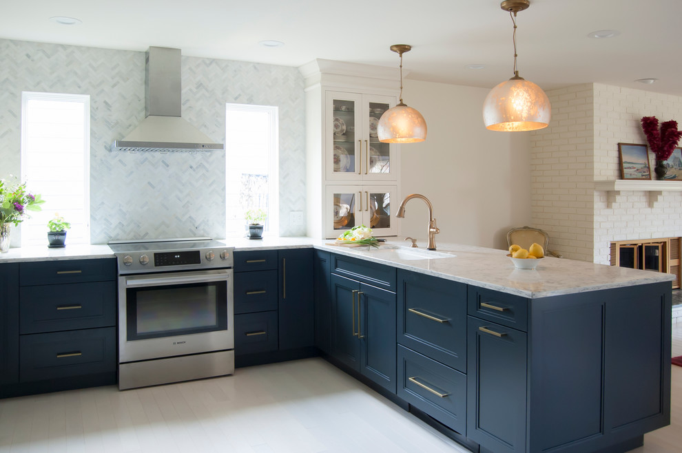 Eat-in kitchen - mid-sized eclectic u-shaped light wood floor eat-in kitchen idea in Chicago with an undermount sink, recessed-panel cabinets, blue cabinets, quartz countertops, multicolored backsplash, mosaic tile backsplash, stainless steel appliances and a peninsula
