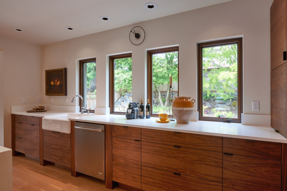 Mid-sized 1950s l-shaped light wood floor eat-in kitchen photo in Seattle with a farmhouse sink, flat-panel cabinets, medium tone wood cabinets, quartz countertops, white backsplash, stainless steel appliances and an island