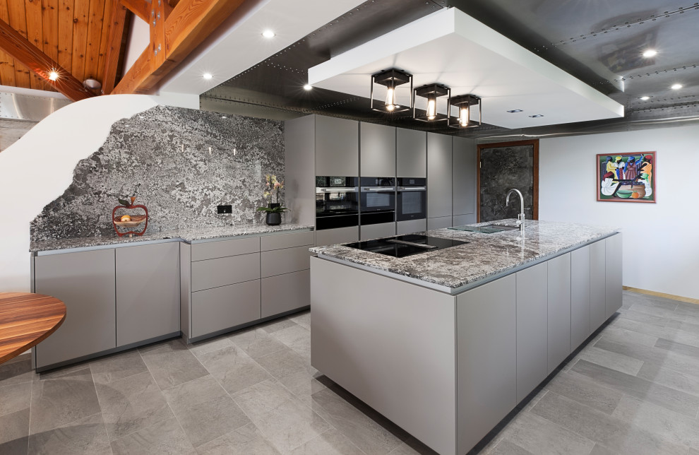 Inspiration for a medium sized contemporary galley open plan kitchen in Glasgow with a submerged sink, flat-panel cabinets, grey cabinets, granite worktops, multi-coloured splashback, granite splashback, black appliances, vinyl flooring, an island, grey floors, multicoloured worktops and a wood ceiling.