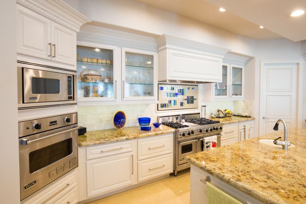 Photo of a large modern u-shaped kitchen in Las Vegas with glass-front cabinets, white cabinets, granite worktops and an island.