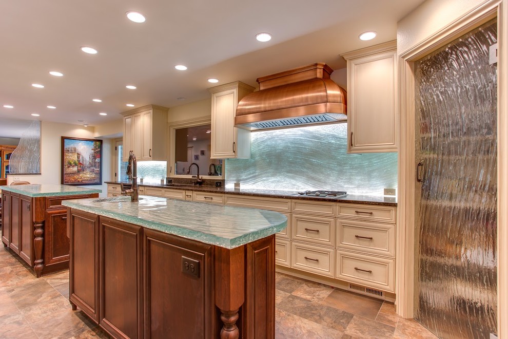 Example of a mid-sized trendy single-wall travertine floor open concept kitchen design in Denver with an undermount sink, recessed-panel cabinets, white cabinets, glass countertops, glass sheet backsplash, two islands, blue backsplash and turquoise countertops