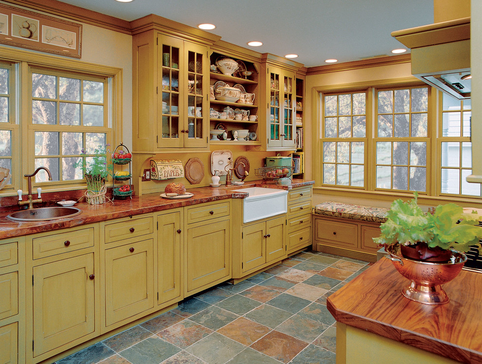 Design ideas for a small farmhouse galley enclosed kitchen in Chicago with a belfast sink, yellow cabinets, copper worktops, yellow splashback, integrated appliances, slate flooring, no island, shaker cabinets and red worktops.