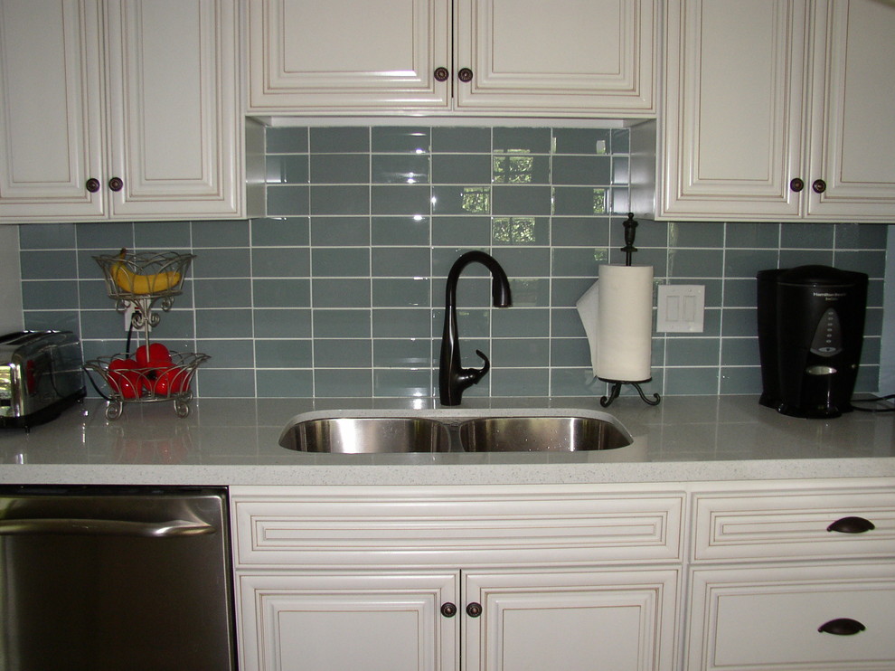 Inspiration for a modern eat-in kitchen remodel in Other with a double-bowl sink, white cabinets, gray backsplash and glass tile backsplash