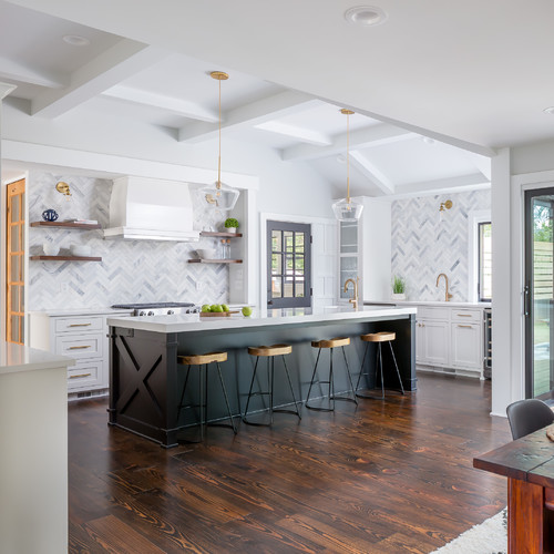 This white and green transitional kitchen has a lot of personality, but still manages to be a little bit formal. The white cabinets are accented with the green kitchen island, which helps the room feel more like a personal space than an office or dining area. The tiles have enough width to stand out from a distance!