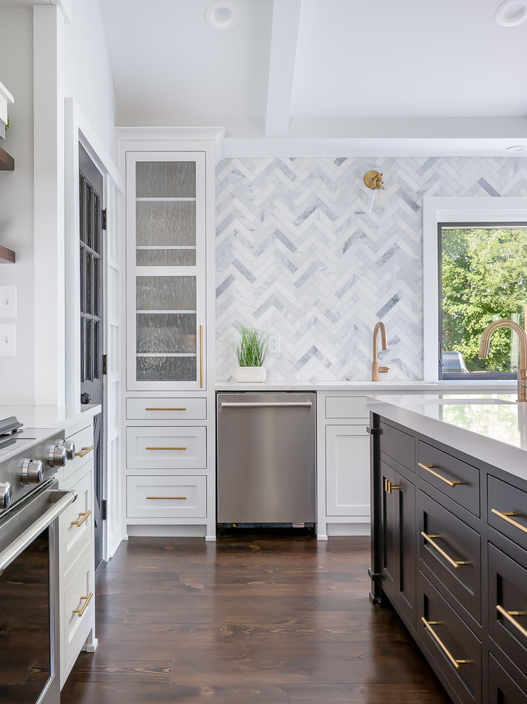 Photo of a large traditional l-shaped kitchen in Raleigh with a submerged sink, shaker cabinets, white cabinets, quartz worktops, grey splashback, marble splashback, stainless steel appliances, dark hardwood flooring, an island, brown floors and white worktops.