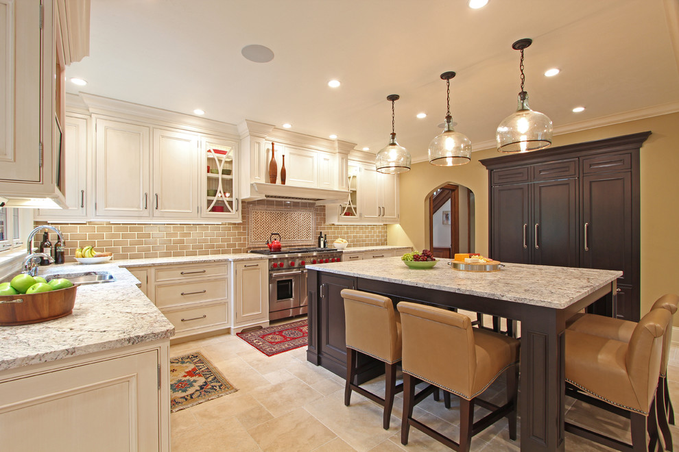Enclosed kitchen - huge traditional u-shaped travertine floor and beige floor enclosed kitchen idea in Other with an undermount sink, beaded inset cabinets, white cabinets, granite countertops, beige backsplash, ceramic backsplash, paneled appliances and an island