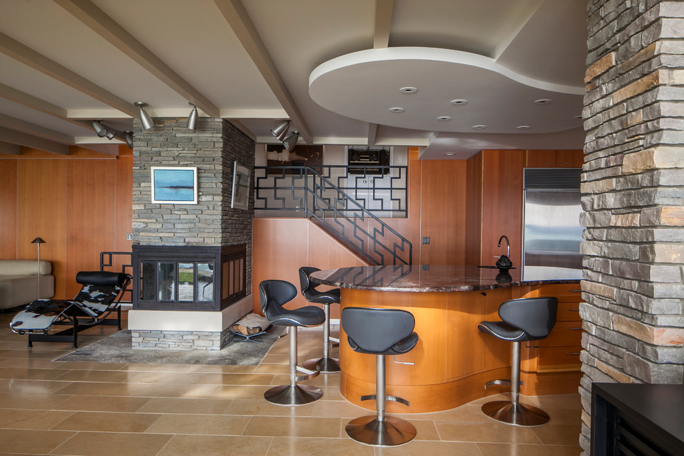 Esempio di una cucina moderna di medie dimensioni con ante lisce, ante in legno chiaro, top in granito, paraspruzzi blu, paraspruzzi con piastrelle di vetro, elettrodomestici in acciaio inossidabile, pavimento in gres porcellanato e lavello sottopiano