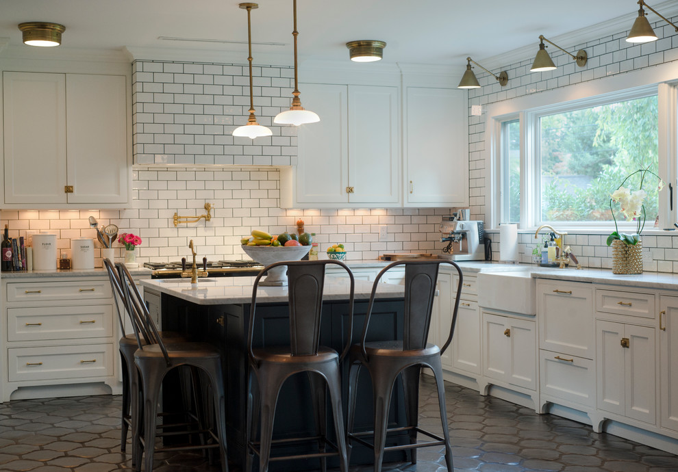 Large transitional u-shaped ceramic tile eat-in kitchen photo in New York with white backsplash, an island, a farmhouse sink, recessed-panel cabinets, white cabinets, marble countertops, subway tile backsplash and paneled appliances